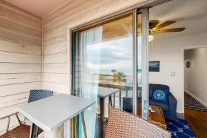 a room with a table and a balcony with a view at La Mirage 302 in Myrtle Beach