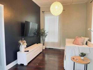 a bedroom with a bed and a table and a window at Cooper Young Bungalow with huge fenced backyard in Memphis
