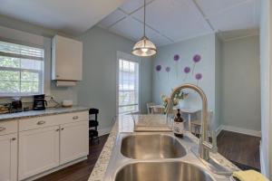 a kitchen with a stainless steel sink in a kitchen at Cooper Young Bungalow with huge fenced backyard in Memphis +18 photos
