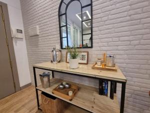 a table with a mirror on a white brick wall at Exclusividad a Pie de la Torre de la Catedral in Granada +12 photos