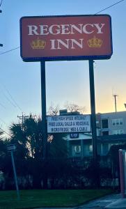 a sign for a recovery inn on a street at Hotel Regency Inn in San Antonio
