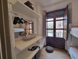 a room with a room with shelves and a window at Exclusividad a Pie de la Torre de la Catedral in Granada