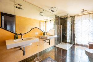 a bathroom with two sinks and a shower at Penthouse Le Terrazze Duomo view in Florence