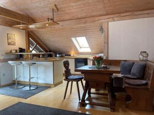 a kitchen with a table and chairs in a room at Alte Villa Traunstein in Traunstein