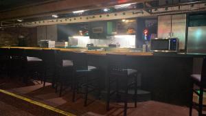 a bar in a restaurant with chairs and a counter at Travelodge by Wyndham Lincoln Northeast in Lincoln +6 photos