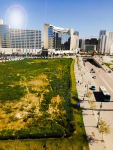 a field of grass next to a street with buildings at NOUVEAU Appartement au plein centre ville en face Hilton M2 in Tangier