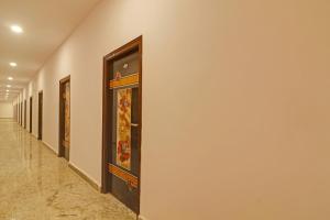 a hallway with a row of paintings on the wall at Super Capital O Hotel Sai Balaji Near Golconda Fort in Hyderabad
