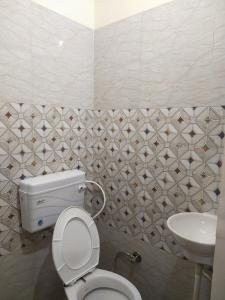 a bathroom with a toilet and a sink at OYO Diamond Guest House in Rudrapur