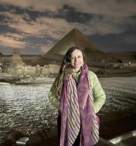 a woman standing in front of the pyramid at Horus Pyramids Inn in Cairo