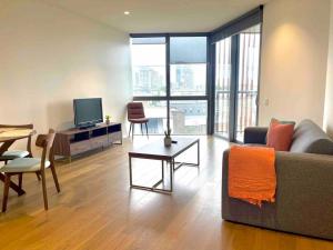 a living room with a couch and a table at Sydney City Side Beauty @ Chippendale 1 Bedroom Aircon in Sydney