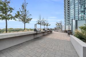 a walkway with benches on a building at Spacious 2BR - Pool Gym Sauna Hot Tub Free Parking in Toronto