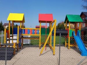 a playground with colorful play equipment in a park at Comfortable holiday cottages, Siano ty in Sianozety