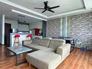 a living room with a couch and a ceiling fan at DS VivacityMall Jazz Suite 3 810 in Kuching
