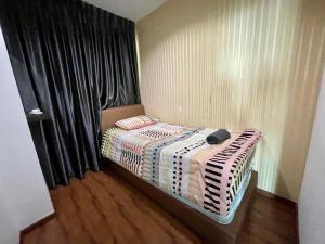 a small bed in a room with black curtains at DS VivacityMall Jazz Suite 3 810 in Kuching +4 photos
