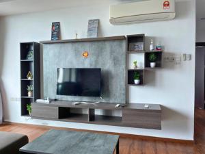 a living room with a flat screen tv on a wall at DS VivacityMall Jazz Suite 3 810 in Kuching