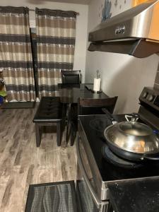 a kitchen with a stove and a dining table at Comfortable room C in Kitchener