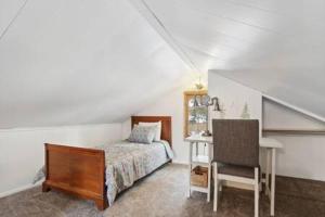 a bedroom with a bed and a desk and a chair at Blue Spruce Cabin in Allenspark