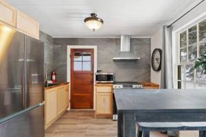 a kitchen with a counter top and a refrigerator at Blue Spruce Cabin in Allenspark +3 photos