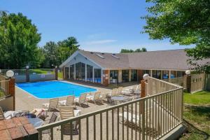 a house with a swimming pool and chairs next to at Free Daily Attractions including Silver Dollar City! Spacious, Centrally located, 2 pools in Branson