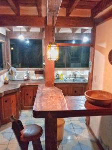 a large kitchen with a counter and a sink at Peña Alta Samaipata in Samaipata