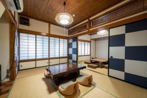 a large room with a table and chairs in it at Seaside House Nagi in Itoigawa