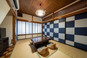 a living room with blue and white checkered wall at Seaside House Nagi in Itoigawa