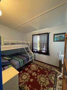 a room with a bunk bed and a window at Long Haven in Iluka
