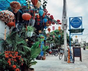 a street with a bunch of flowers and plants at Golden Lantern Tam Thanh Homestay in Tam Kỳ