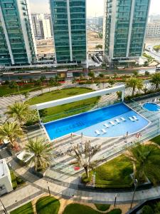 an overhead view of a pool in a city with tall buildings at Cozy studio, amazing amenities in Dubai