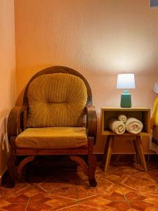 a chair sitting next to a table with a lamp at Casa Esperanza in Panajachel