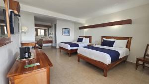 a hotel room with two beds and a desk at Best Western Riviera Tuxpan in Tuxpan de Rodr&iacute;guez Cano