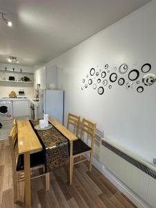 a kitchen and dining room with a table and chairs at Perfect in the centre with view in London