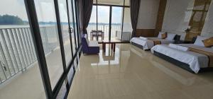a hotel room with two beds and a balcony at Khách sạn Lake Side Palace - Bờ Hồ in Phuoc Buu