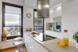A kitchen or kitchenette at Cozy Family Apartments on Grzybowska Street with Parking