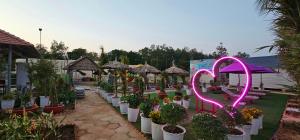 a garden with potted plants and a heart sign at Khách sạn Lake Side Palace - Bờ Hồ in Phuoc Buu