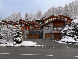 a large house with snow on the ground at Chalet Beaufort in Saint-Martin-de-Belleville
