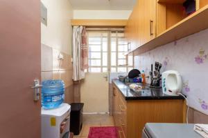 une petite cuisine avec évier et comptoir dans l'établissement Homely Queen Bed Apartment Near Nairobi CBD, à Nairobi