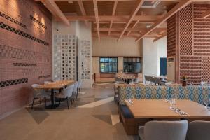 a dining room with wooden tables and chairs at Citadines Roces Quezon City in Manila