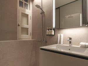 a bathroom with a sink and a shower at Hotel 1900 Chinatown in Singapore