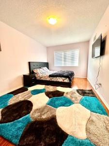 a bedroom with a bed and a large rug at Golden Spring Beautiful home in Brampton