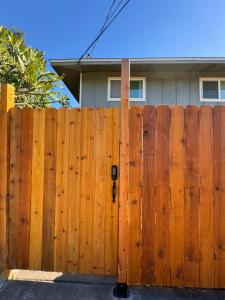 a wooden fence in front of a house at Mailan Hale Hostel in Kailua-Kona