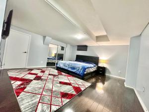 a bedroom with a bed and a rug on the floor at Golden Spring Beautiful home in Brampton