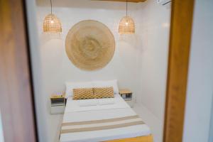 a small room with a bed and two pendant lights at Private Villa with Pool in Vigan, Ilocos Sur - Selene Private Villas in San Vincente