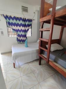 a room with a bunk bed and a ladder at Mandurah's Inn, Malapascua in Malapascua Island