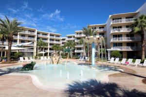 a pool with a fountain in front of a resort at Waterscape C605 - Top Floor Beach Views - Free Beach Service - Interior Facing! in Fort Walton Beach