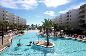 a pool at a resort with people swimming in it at Waterscape C605 - Top Floor Beach Views - Free Beach Service - Interior Facing! in Fort Walton Beach