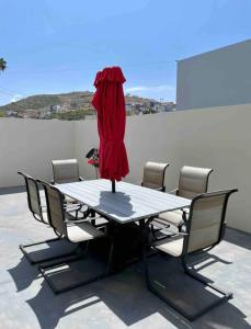 a table with a red dress on top of it at Casa Santacruz in Ensenada