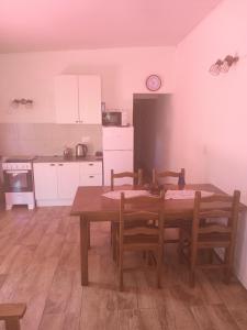 a kitchen with a wooden table and a table and chairs at Casita colonia in Colonia del Sacramento +18 photos