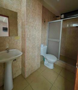 uma casa de banho com um WC, um lavatório e um chuveiro em Hotel Río Tena em Tena