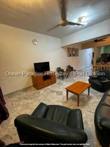 een woonkamer met een bank en een tafel bij Ocean Paradise homestay @ port dickson in Port Dickson